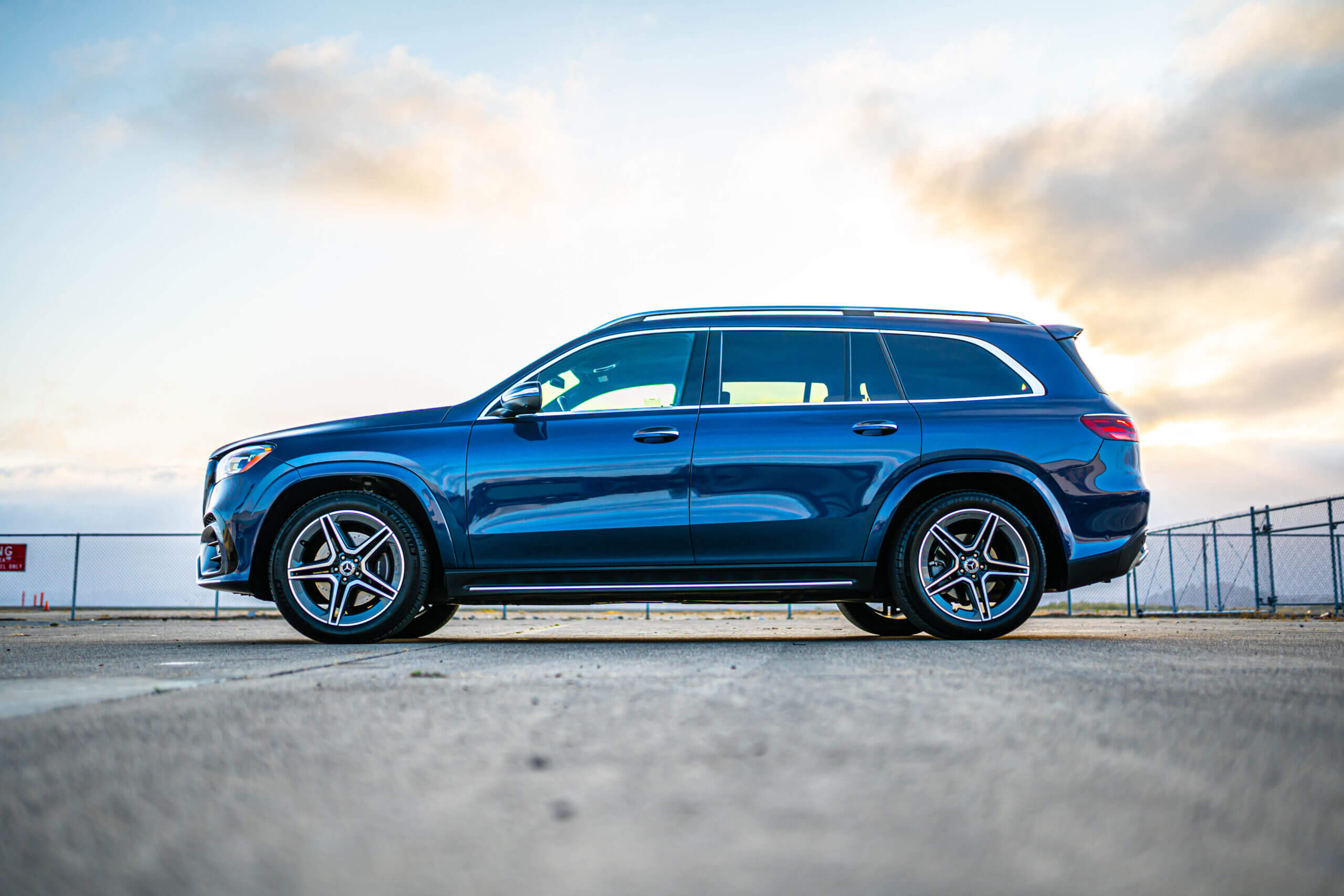 Side view of a blue Mercedes-Benz GLS luxury SUV parked outdoors
